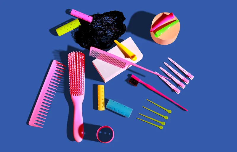 Vibrant flat lay of hair accessories on a blue background for hair care enthusiasts